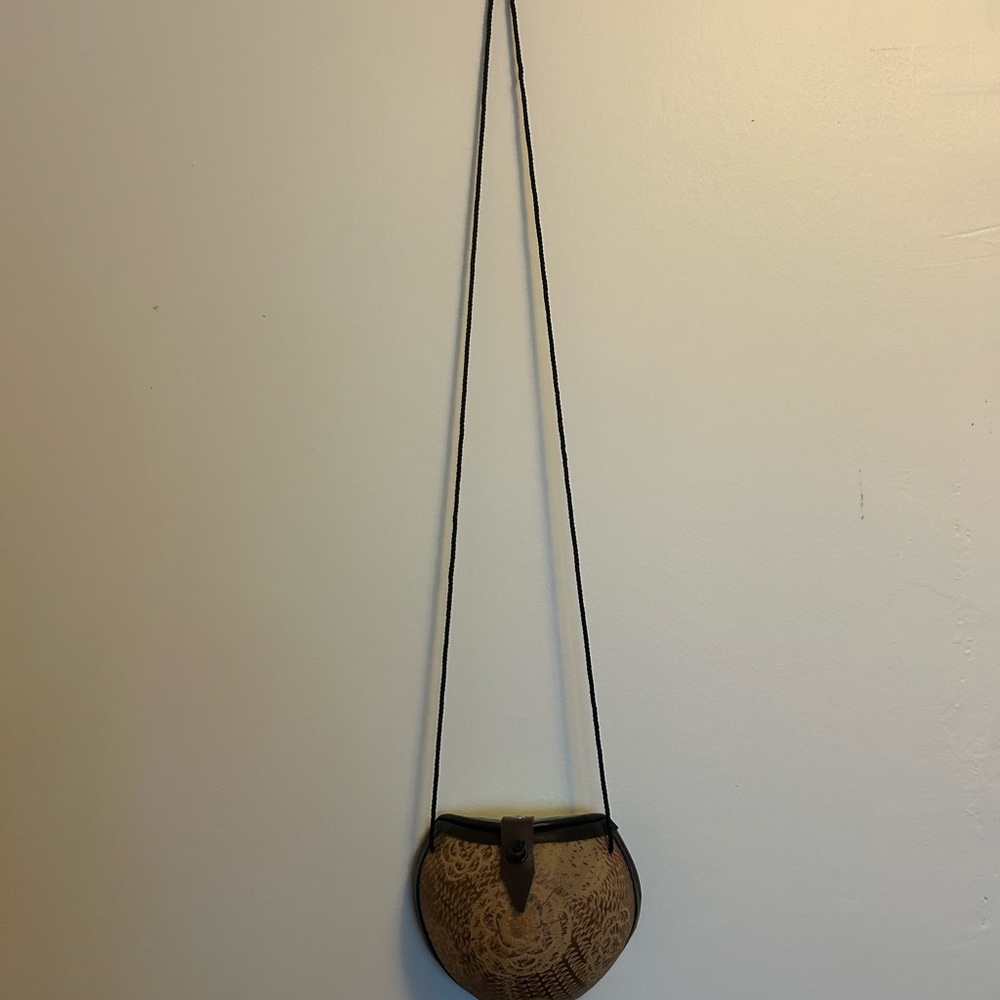 Round Tan Coconut Crossbody Bag with Floral Embossing
